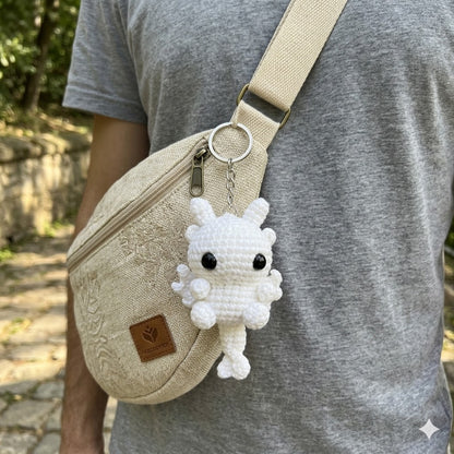 Handmade crochet dragon couple keychains in black and white, fantasy animal bag charms by WoolyArtis, perfect for matching accessories.