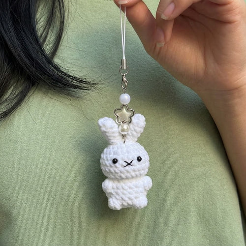Cute WoolyArtis crochet Hello Kitty keychain featuring a handmade amigurumi plush bag charm with adorable details.