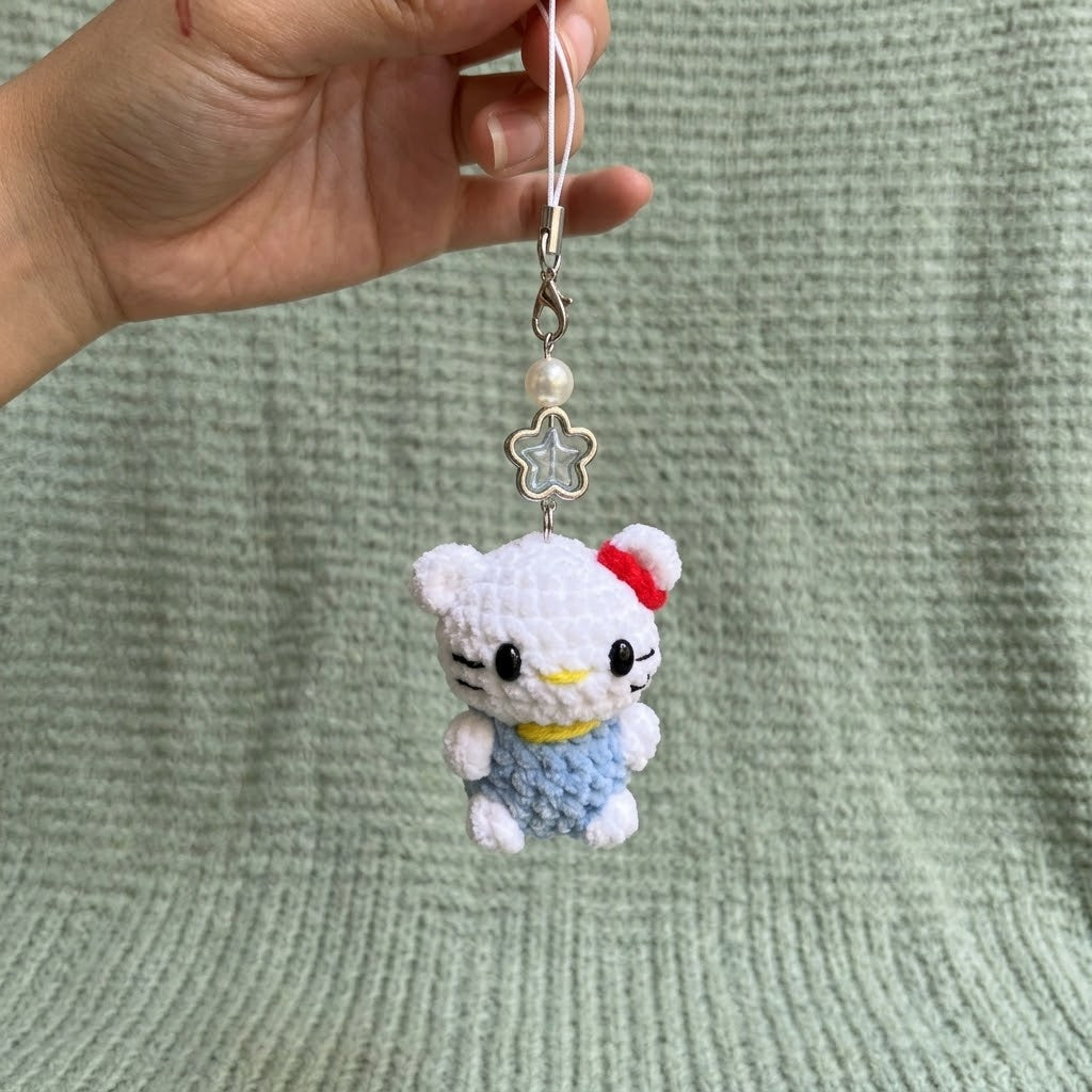 Handmade WoolyArtis Cute Crochet Hello Kitty keychain with plush amigurumi design, perfect as a bag charm or accessory.