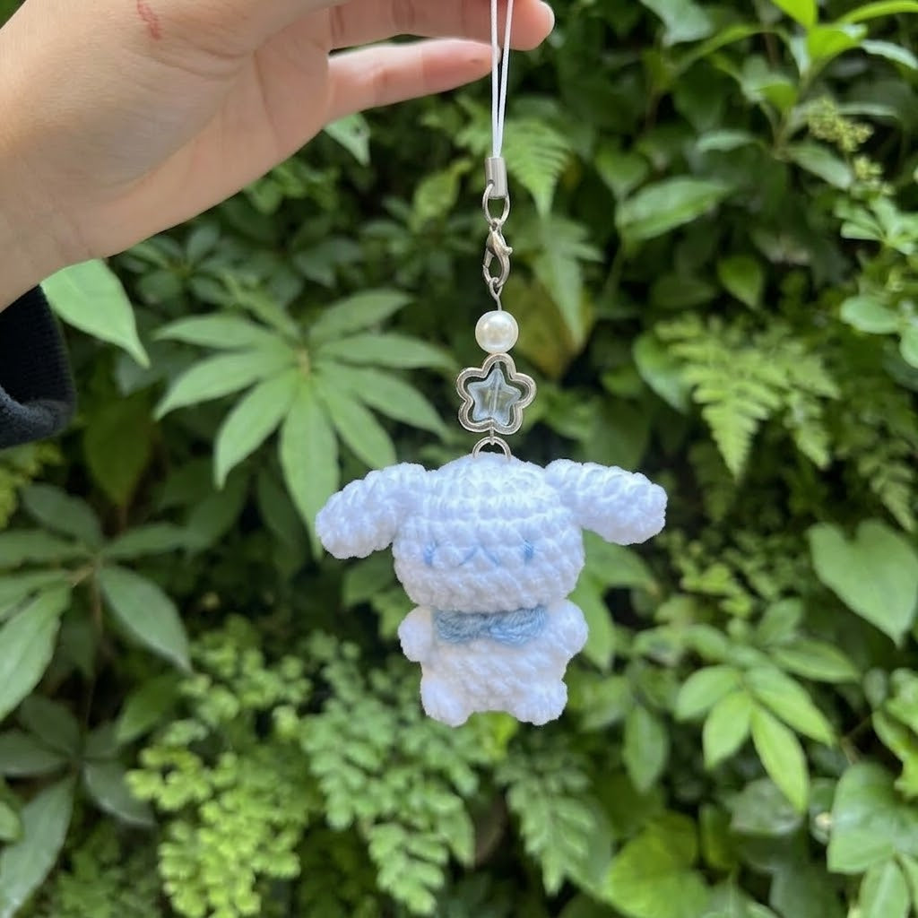 Cute WoolyArtis crochet Hello Kitty keychain featuring an amigurumi plush bag charm with detailed pink bow and white cat face.